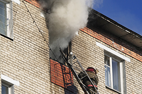 fireman extinguish a fire in a high-rise apartment in Vladivostok city, Russia